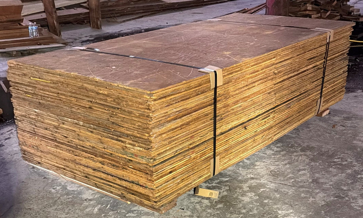 Bundled reclaimed plywood sheets processed for reuse by Sledge Seattle